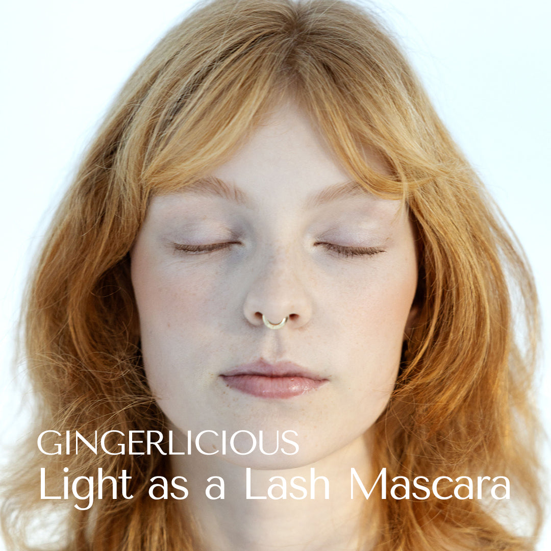 Nymph like model vith angel skin and strawberry blond hair wearing Gingerlicious Mascara. Light as a Lash Mascara. Hey Redhead. Closed eyes. Brows and lashes.