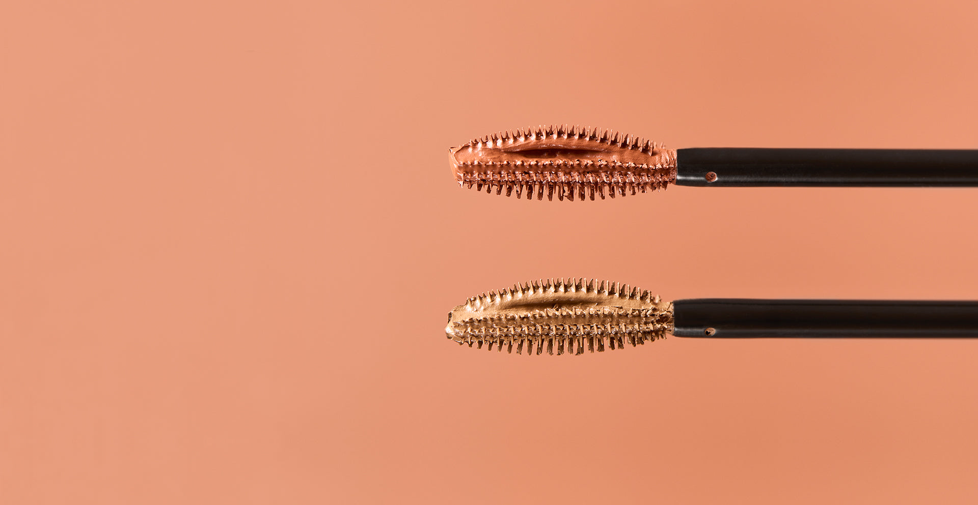 HEY REDHEAD Mascara, both shades on light brown background. two mascara brushes. 